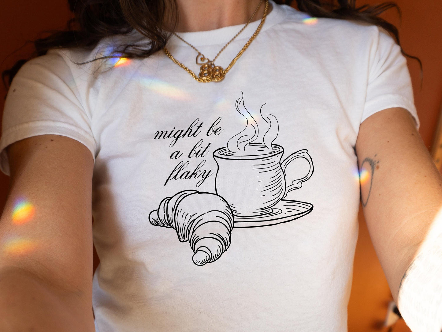 Might Be A Bit Flaky Baby Tee, Funny Slogan T-Shirt, Coffee Club Shirt, Croissant Shirt, Coffee Lover Shirt, Womens White Baby Tee T-Shirt